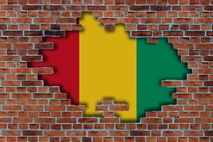 3D Flag of Guinea behind the broken old stone wall background. photo