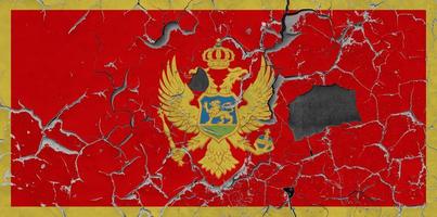 3D Flag of Montenegro on an old stone wall background. photo