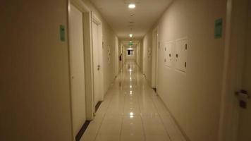 The hallway of an apartment or dormitory is quiet and spooky. With yellow lights and a very quiet atmosphere, it makes the atmosphere a bit quiet and spooky. video