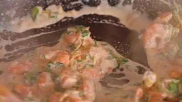 Cooking shrimp in garlic-cream sauce closeup video