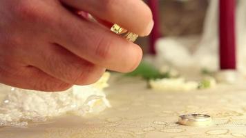 Wedding rings with candles and flowers video