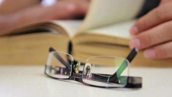 Male student reading book withoot glasses video