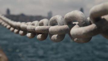 Guard bars on seaside with city view, thick guard rails by sea sway beause of wind, selective focus video