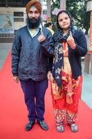 New Delhi, India - April 04 2023 - Unidentified people showing their ink-marked fingers after casting votes in front of polling booth of east Delhi area for MCD local body Elections 2022 photo