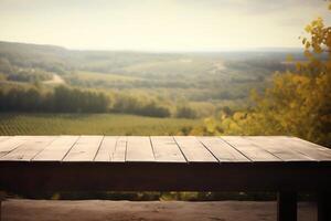 Empty wooden table with blurred French vineyard in background. photo