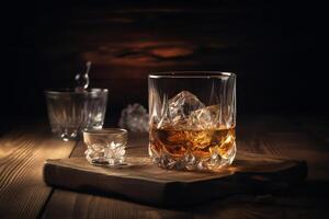 Whiskey with ice on wooden table. photo