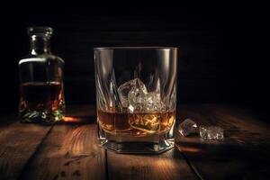 Whiskey with ice on wooden table. photo
