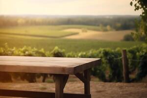 Empty wooden table with blurred French vineyard in background. photo