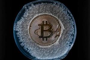 Bitcoin frozen inside ice cube, Bitcoin price crisis concept. Neural network generated art photo