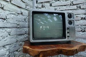 Retro old orange TV receiver on table photo