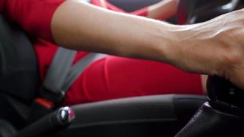 Frau im rot Kleid Befestigung Auto Sicherheit Sitz Gürtel während Sitzung Innerhalb von Fahrzeug Vor Fahren video