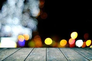 Wood Table with Bokeh of Christmas Lights Background, Suitable for Product Display. photo