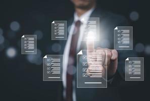 Business people hand touch Online documentation database, complete the online survey form, answer the test questions. Marked checklist on a clipboard. Human resources and management concept, BigData photo