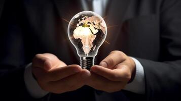 Businessman holding a glowing lightbulb in his hand. Business and innovation concept. photo