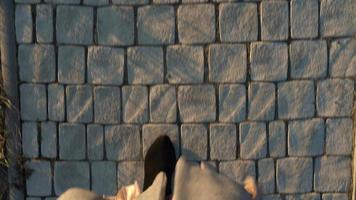 Top view of female legs in boots walking on the sidewalk video