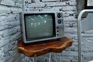 Retro old orange TV receiver on table photo