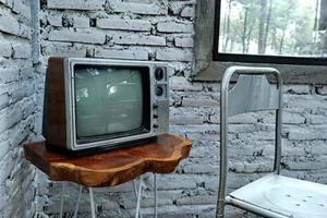 Retro old orange TV receiver on table photo