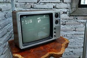 Retro old orange TV receiver on table photo