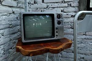 Retro old orange TV receiver on table photo