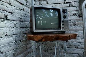 Retro old orange TV receiver on table photo