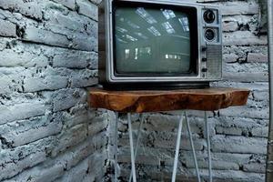 Retro old orange TV receiver on table photo