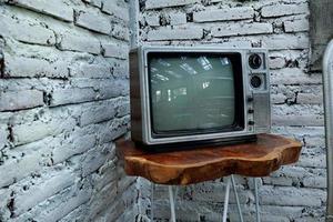 Retro old orange TV receiver on table photo