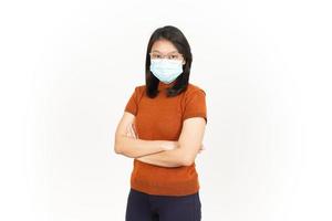 Wearing Mask And Folding Arms Of Beautiful Asian Woman Isolated On White Background photo