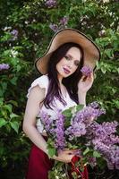 A fashionable girl with dark hair, a spring portrait in lilac tones in summer. Bright professional makeup. photo