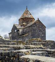 Old stone church in rural field scene concept photo. Monastery complex located on the hill. High quality picture for wallpaper photo