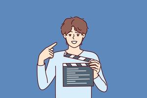 Man producer with clapboard in hands looks at screen while working on set of film or clip with Hollywood actors. Guy director or producer points finger at face, recommending staff of set to smile vector