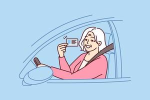 Happy elderly woman demonstrates driver license sitting behind wheel of car and rejoices at opportunity to go on road trip. Positive grey-haired old lady got driver ID after retirement vector