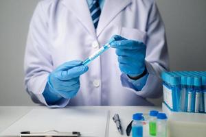 Close up view of scientist researcher testing laboratory experiment with glass equipment in the lab. photo