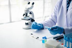 Close up view of young professional scientist performing laboratory experiments. photo