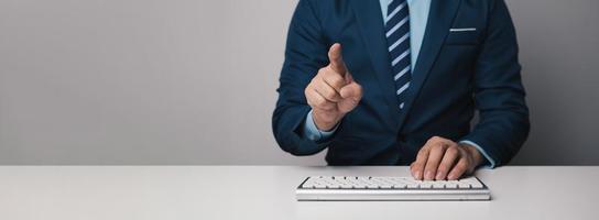 Young professional businessman typing on keyboard computer with copy space. photo