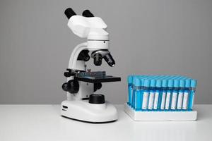 Science laboratory research and development concept. microscope with test tubes. photo