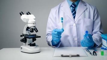 Close up view of scientist researcher testing laboratory experiment with glass equipment in the lab. photo