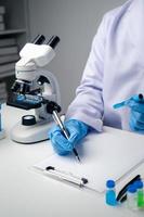 Close up view of scientist researcher testing laboratory experiment with glass equipment in the lab. photo