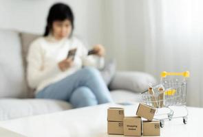 woman using smartphone for online shopping at home. Hand holding mobile phone with payment detail page display and credit card, stay home, technology, electronic commerce, internet, market place photo