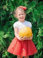 Child holding pumpkin photo