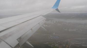 Airplane wing, view from the porthole. Airplane flies over the clouds video