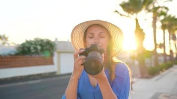 Photographer tourist woman taking photos with camera in a beautiful tropical landscape at sunset video