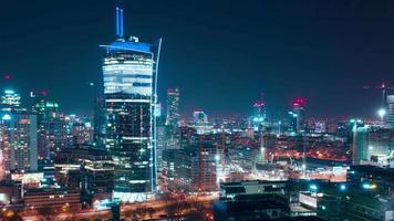 Aerial hyperlapse of Warsaw business center at night skyscrapers and Palace of Science and Culture video