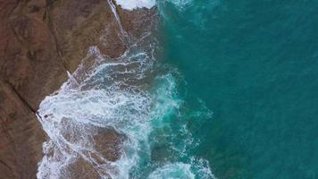 Top view of the desert beach on the Atlantic Ocean. Coast of the island of Tenerife. Aerial drone footage of sea waves reaching shore video