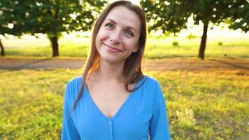 Portrait of pretty woman with hat outdoors in sunny day closeup video