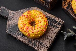 Delicious fresh donuts in yellow glaze with lemon flavor filling photo