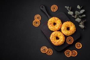 Delicious fresh donuts in yellow glaze with lemon flavor filling photo