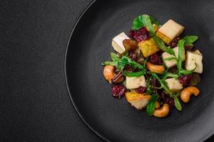 Delicious fresh vegan salad with pear, brie cheese, nuts and grains, and arugula photo