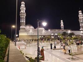 Medina, Saudi Arabia, April 2023 - A beautiful view of the building and minarets  of the Quba Mosque in Medina, Saudi Arabia at night. photo