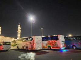 Medina, Saudi Arabia, April 2023 - A beautiful view of the building and minarets  of the Quba Mosque in Medina, Saudi Arabia at night. photo