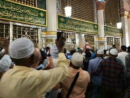medina, saudi arabia, abril 2023 - musulmán peregrinos son yendo a visitar roza rasool a masjid Alabama nabawi medina foto